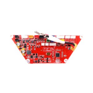 Red printed circuit board with numerous components and white ribbon cable connection, mounted on a shaped panel.